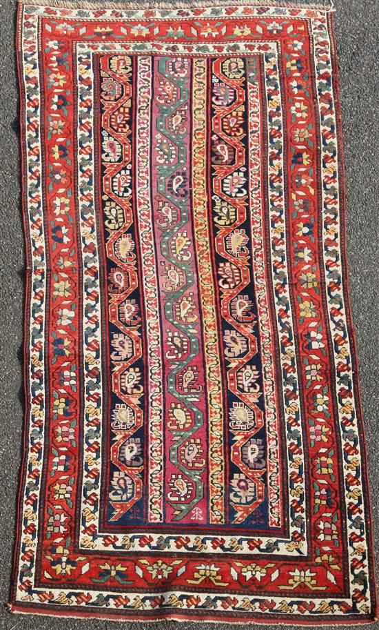 A Kazak multi coloured rug, c.1900, 7ft 9in by 3ft 9in.